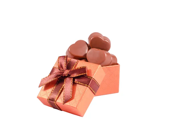 Chocolate candies in the shape of a heart in a gift box isolated on a white background.