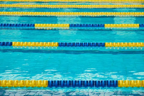 Turquoise swimming pool lanes, a symbol of sport