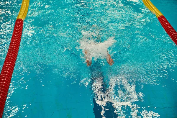 Turquoise swimming pool lanes, a symbol of sport