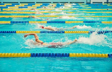 Turquoise swimming pool lanes, a symbol of sport. Athletes swim freestyle. clipart