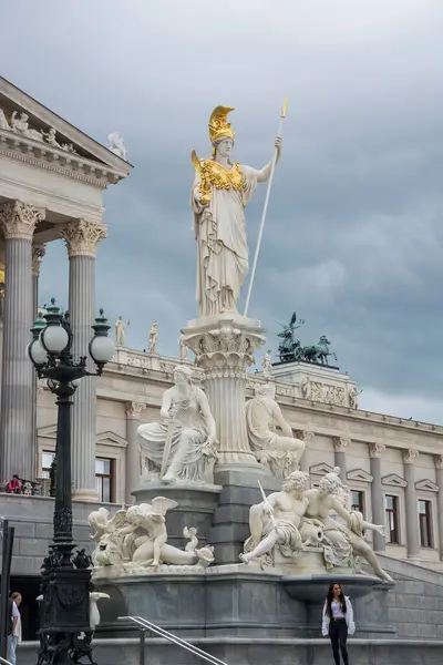 stock image Editorial. 1 June, 2024. Vienna, Austria. Fountain of Pallas Athena near the Parliament House, built by Karl Kundmann in 1902, four bronze groups of horse tamers, created by Lax; a series of statues rising against the sky, as well as statues of Greek