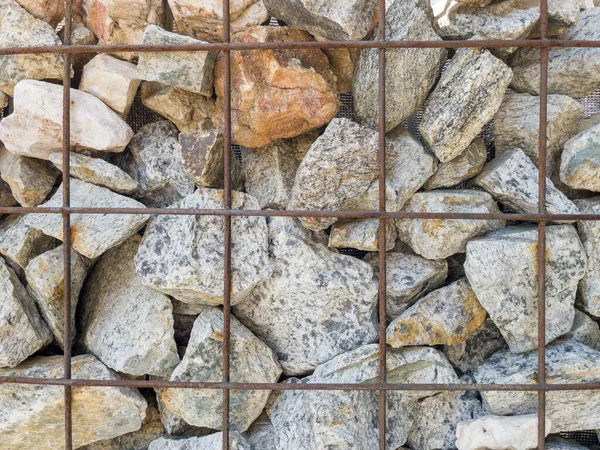 stock image stone wall behind chain link fence background.