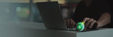 a person using a laptop with a glowing green money bag icon hovering near the keyboard. The image represents digital financial transactions, online banking, and secure money transfers.  clipart