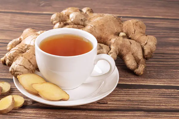 fresh and healthy ginger tea with ginger root on table
