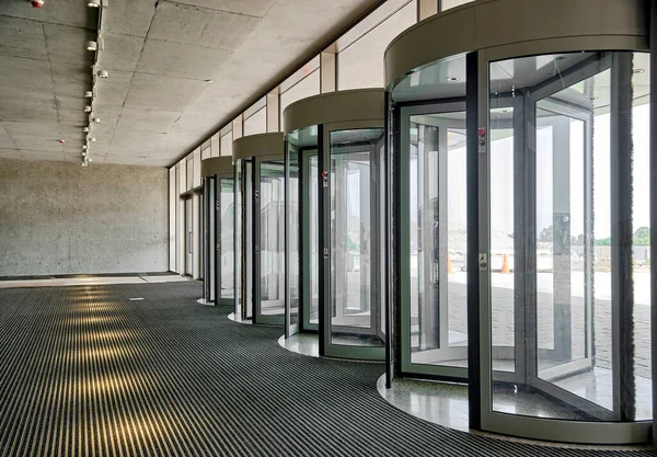 Revolving doors. The facade of a modern shopping center or station, an airport with revolving doors. Modern office entrance glass revolving door