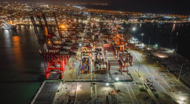 View of dock and containers in the port of Callao. Bulk and car carrier stay alongside the berth and have cargo operations clipart