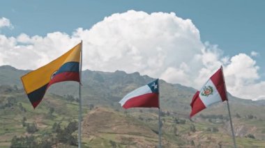 Gökyüzünde iki bayrak dalgalanıyor. Biri kırmızı ve beyaz bir bayrak.