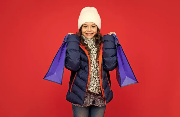 Happy Kid Puffer Jacket Hat Teen Girl Shopping Red Background — Stock Photo, Image