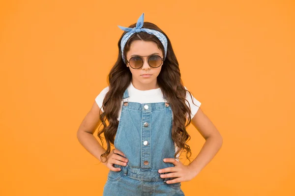 Fashion trend. You can have anything you want in life if dress for it. Little fashionista. Cute kid fashion girl. Summer fashion concept. Girl long curly hair wear sunglasses and fancy tied headscarf.