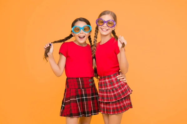 summer vacation. party time. school prom party. red fashion girls. happy little girls in checkered skirt. funny kids in school uniform. Small girls wearing fancy glasses. summer is soon. wow.