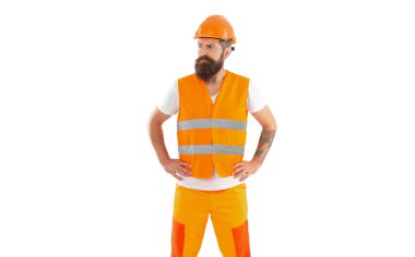 Üniformalı üzgün müteahhit. Turuncu yelekli sakallı müteahhit. Miğfer takan inşaatçının stüdyo fotoğrafı. Yapıcı beyaz arkaplanda izole edildi.