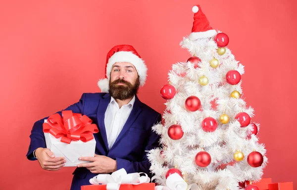 Quick gift delivery. winter season sales. christmas shopping. bearded man santa hat. new year surprise. man celebrate party at xmas tree. Gift service concept. Send or receive christmas present.