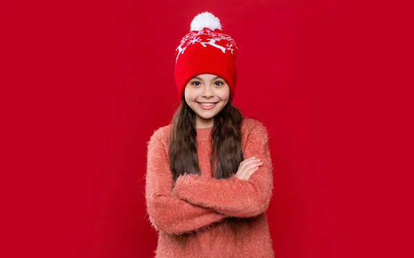 スタジオでは10代の子供がセーターと帽子を着て 10代の子供の冬のファッション 帽子のニットウェア 帽子の10代の子供モデル 赤い背景に隔離された帽子の10代の子供 — ストック写真