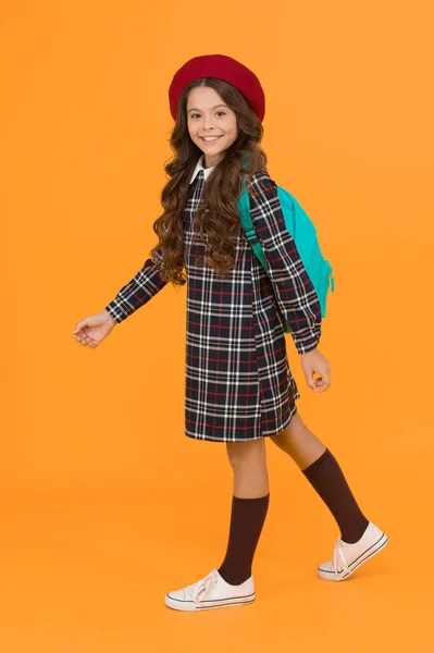 one more step. knowledge day. happy childhood. french style concept. back to school. retro girl wear uniform and parisian beret. kid school fashion. cheerful child ready for schoolyear. education.