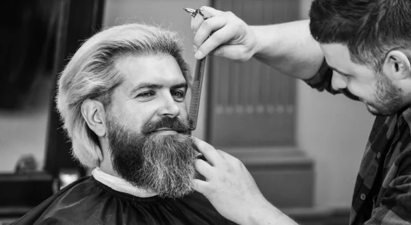 It is just unbelievable. male hairdresser in workshop. bearded man. hair and beard care. confident and handsome brutal man. grooming hair in barbershop. male beauty and fashion. making new hairstyle.