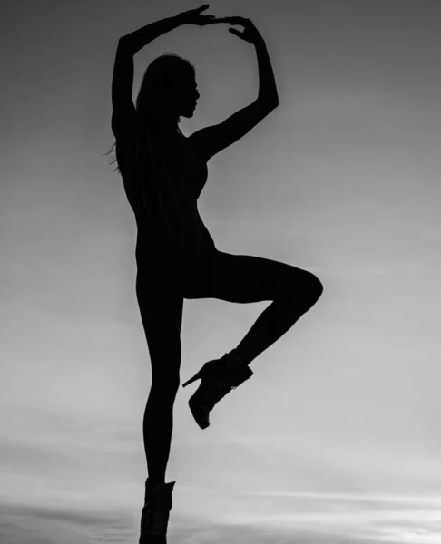 ballet dancer. dancing in evening. shade and shadow. woman silhouette on sky background. sense of freedom. female silhouette on sunset. woman dance in sunrise. dark figure of dancer.