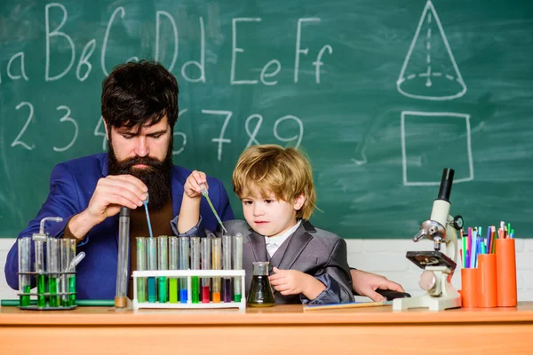 stock image Perseverance pays off. Chemical experiment. Symptoms of ADHD at school. Educational school program. Schoolboy cute child experimenting with liquids. Teacher and child test tubes. School lesson.