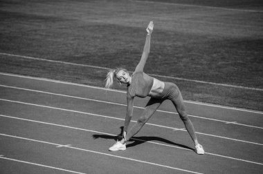 Vücuduna uygun. Kadın sporcu spor yapıyor. Antrenör ya da koç eğitimi. Mükemmel vücut şekli. sağlıklı ve sportif. Spor giyim bölümündeki seksi fitness kadını. Atletik bayan stadyumda ısınıyor..