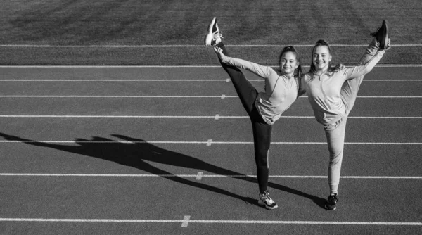 Happy Teenage Gymnasts Vertical Splits Holding Legs Athletics Track Copy — Stock Photo, Image