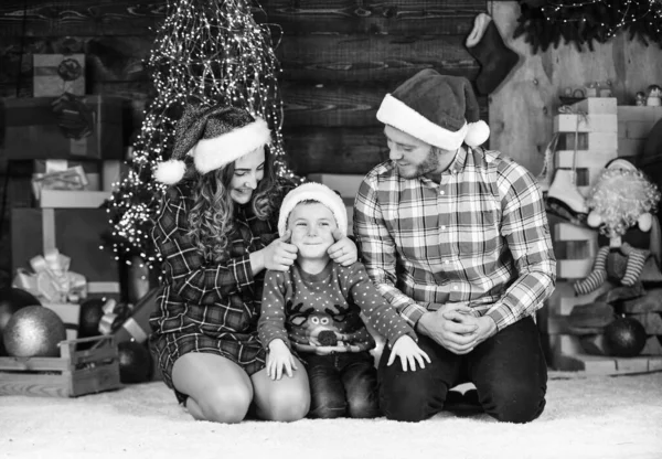 Winter holidays. Christmas tradition. Father mother little son christmas tree background. Idyllic moment. Parenthood happiness. Family values. Spend time with family. Parents child waiting for Santa.