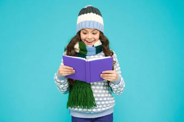 Interesting information. Library concept. Reading skills. Winter story. Girl reading book. Kid enjoying book. Little book lover. My favorite story. Leisure in winter time. Childhood development.