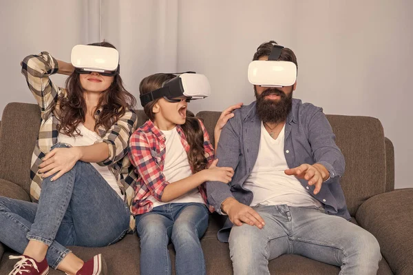digital future and innovation. modern life. father mother and child wireless VR glasses. virtual reality family. amazed parents with kid girl use modern technology. mom dad and daughter.