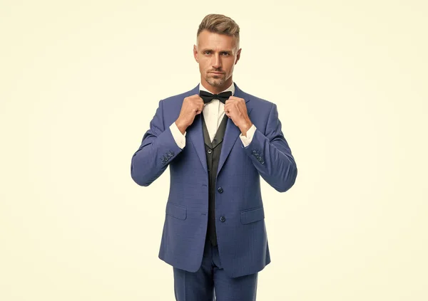 grizzled man in blue suit and bow tie. businessman isolated on white. boss in formal wear.