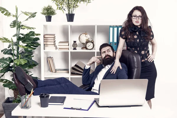 Lazy boss office. Offer massage. Man bearded hipster boss sit in leather armchair office interior. Boss and secretary girl at workplace. Relations at work. Business people and staff concept.