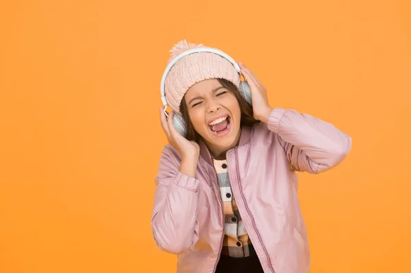 Dedicated to singing. Small singer yellow background. Happy girl enjoy singing to music. Singing lesson. Vocal exercises. Learn to sing. Music school. Her singing voice is really lovely.
