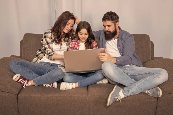 family blog. happy parents with kid girl study online. curious mom dad and daughter shopping on cyber monday. modern education and communication. video call. father mother and child use laptop.