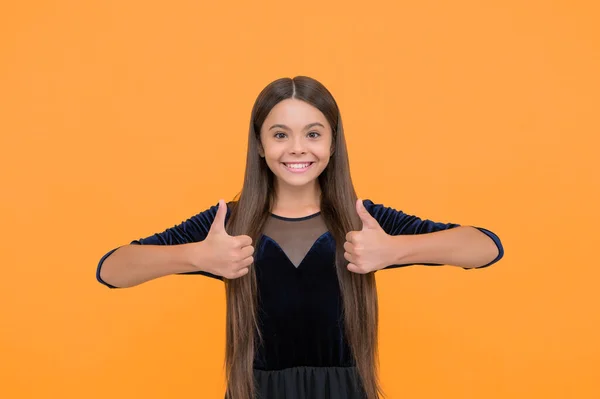 stock image Satisfaction guaranteed. Happy child show thumbs ups yellow background. Satisfactory hand gesture. Satisfaction concept. Fashion and style. Hair salon. Beauty and look.