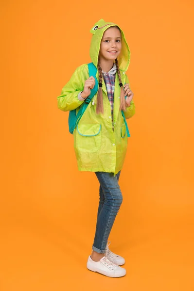 Waterproof cloak. Waterproof fabric for your comfort. Rainproof accessory. Schoolgirl hooded raincoat enjoy rainy weather. Waterproof clothes every kid should try. Kid girl happy wear raincoat.
