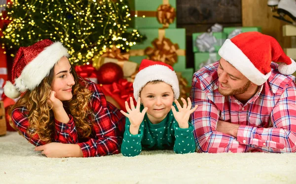 Home is the best place in the world. new year at home. family christmas portrait. happy family celebrate xmas. son with parents in santa hat. little kid boy love mom and dad. having fun.