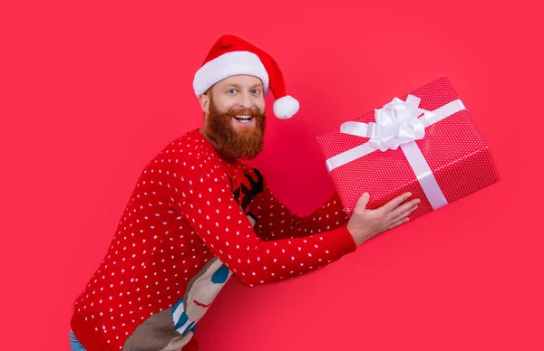 happy man with new year present. new year sale. santa man hurry up with new year present isolated on red.