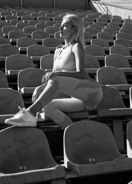 athletic woman in fitness wear relax on stadium, relax.