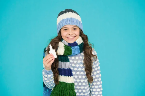 treat runny nose with drops. free your stuffy nose. happy teen girl in knitwear hold nasal spray. kid winter fashion style. child care of health. coronavirus pandemic quarantine. healthy childhood.