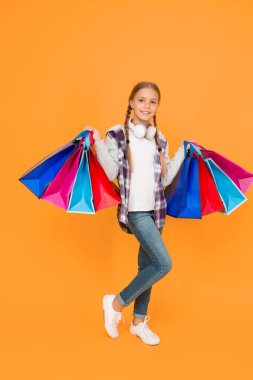 black friday. hurry up its total sale. Kids fashion. Sales and discounts. happy small girl after successful shopping. adorable child with heavy bags. Best outfit ever. holiday gifts in packages.