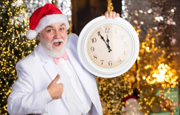 ガーランド照明の背景 サンタの帽子の髭のビジネスマン タキシード姿のサンタさん クリスマス サンタは時間を数える 真夜中のコンセプト 新年のカウントダウン レトロな時計の男 — ストック写真