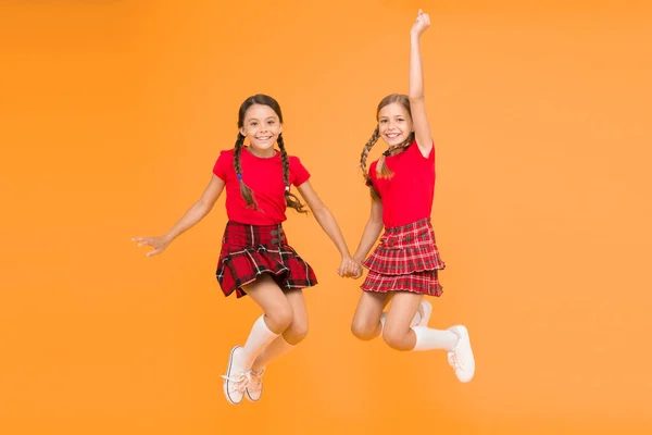 Scottish Style Cheerful Friends Schoolgirls Jumping Yellow Background Celebrate Holiday — Stock Photo, Image