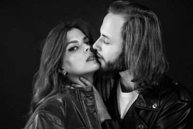 Erkeğe ve kadına aşık şık bir çift deri ceket giyer, öpüşürler..