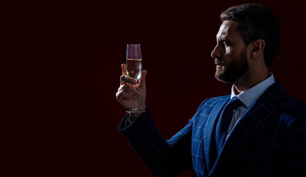 sommelier man in studio cheering. sommelier cheering isolated on red background. man sommelier cheering, copy space. man sommelier cheering with champagne.