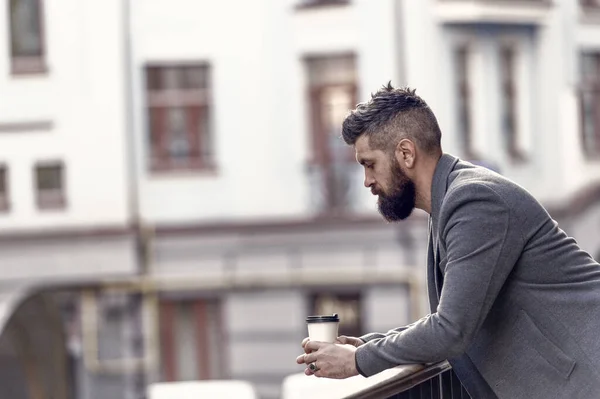 Life begins after coffee. Bearded man enjoying morning coffee. Businessman in hipster style holding takeaway coffee. The best time of day to drink coffee. Hipster with paper cup walking in city.