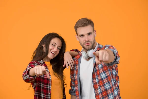 Simple casual clothes. Couple feeling comfortable. Country music concept. Country style. Woman and man wear checkered shirt. Rustic and country. Sexy people. Youth fashion. Fashionable outfit.