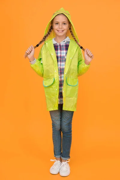 Waterproof cloak. Waterproof fabric for your comfort. Schoolgirl hooded raincoat enjoy rainy weather. Rainproof accessory. Waterproof clothes every kid should try. Kid girl happy wear raincoat.