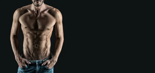 abs and torso. advertisement banner of man with having muscular abs and torso. young man with muscular torso and abs isolated on black. studio shot of muscular man.