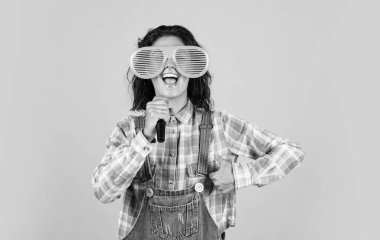 feel a success. Have Fun on Celebration. woman singing with microphone in karaoke. young hipster TV reporter is broadcasting. singer with microphone. presenting an event. happy girl enjoy the moment.