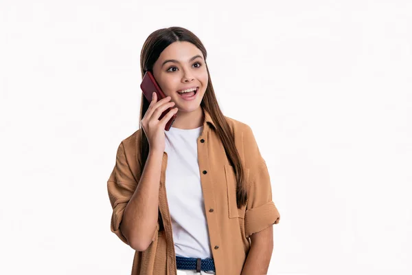 stock image amazed teen girl has smart phone conversation isolated on white. teen girl has conversation on smartphone. teen girl with smartphone has conversation in studio. conversation of teen girl on smartphone