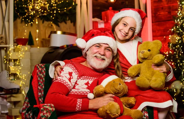 I love my grandpa. family holiday weekend. Little girl with santa man. grandpa and grandchild at home. xmas happiness and joy. Present for kid. father and daughter love christmas. happy new year.