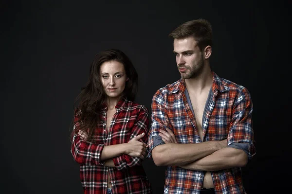Country style. Woman and man wear checkered shirt. Rustic and country. Sexy people. Youth fashion. Fashionable outfit. Simple casual clothes. Couple feeling comfortable. Country music concept.