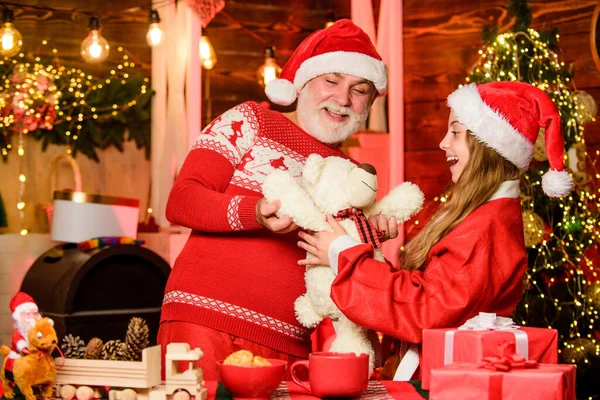 stock image its lovely. father and daughter love christmas. grandfather and grandchild at home. xmas happiness and joy. gift for child. family holiday weekend. small girl with santa man. happy new year.